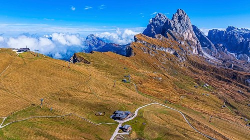 Sofie hut, behind the peaks Sas Rigais and Furchetta of the Geisler group, drone shot, Val Gardena,