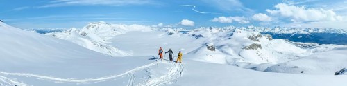 Three ski tourers in front of a snow-covered glacier plain, Plaine Morte Glacier, Bernese Alps,