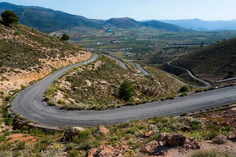 Winding road through a green mountain landscape to Mirador Laujar, Laujar de Andarax, Province of