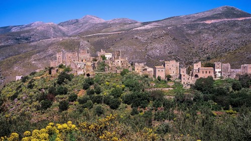 Mountain village with historic buildings surrounded by green vegetation and mountains, Vathia,