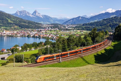 Railway passenger train of the type Stadler Flirt of the Südostbahn on the mountain Großer Mythen