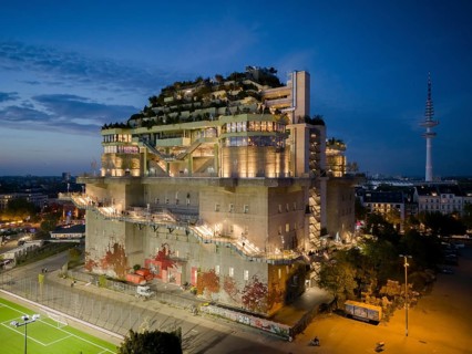 Hamburg bunker with green roof, external stairs and stylish lights in an urban setting at blue hour