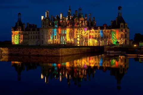 Chambord Castle with summer evening light show and moat, Chambord, Loir-et-Cher department, Centre