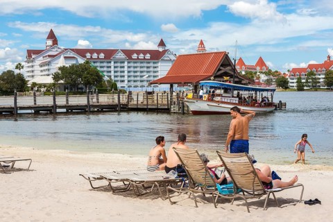 Disney's Polynesian Resort guests enjoy the beach overlooking the Grand Floridian Resort in Walt