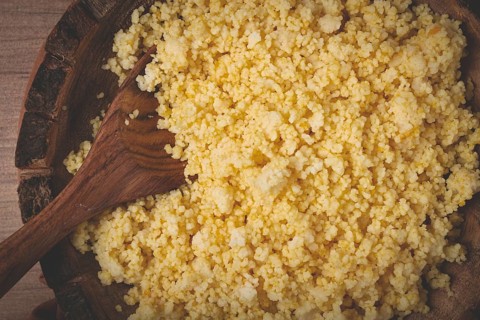 Cooked couscous, in a wooden bowl, top view, no people