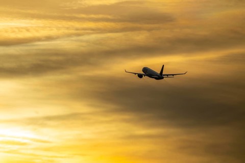 Aeroplane after take-off from Düsseldorf airport, sunset