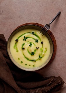 Mashed potatoes, with green butter and micro greenery, homemade, on a beige table, no people, top