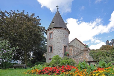 Historic stag tower built in 1330, town tower, empty bench, flower bed, Zell am Harmersbach,