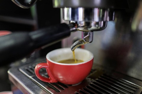 Symbol photo on the subject of making coffee. Coffee runs out of a Siebtraeger coffee machine into