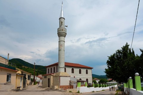 View of a mosque with a slender minaret on a street with pedestrians, Melivia, Melivoia, centre of