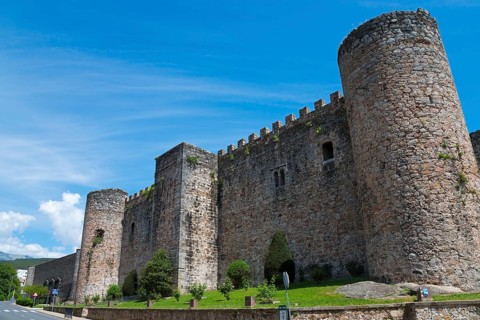 Massive medieval castle wall with stone towers under a clear blue sky, Castle, Castillo de la