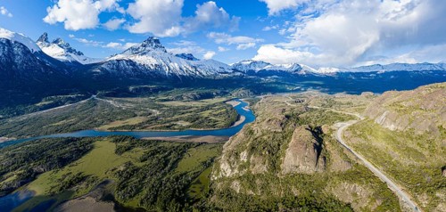 Confluence of river Estero Parada flowing into Rio Ibanez, aerial view, snow-capped mountains in