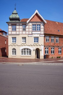 Listed residential building with imitation half-timbering, Welscher bonnet and triangular gable