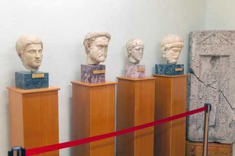 Carved marble Roman portraits head of four men, archaeology museum, Apollonia Archaeological Park,