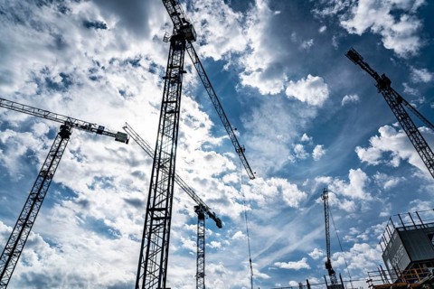 Construction cranes on two large construction sites, construction of office buildings in