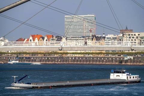 Cargo ships on the Rhine near Düsseldorf, bridge over the Media Harbour, Oberkassler Rhine Bridge,