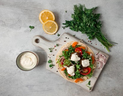 Tortilla with falafel and vegetable salad, white sauce, Arabic cuisine, top view, homemade, no