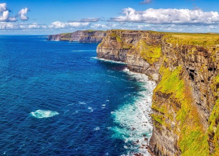 Dramatic cliff landscape with impressive coastline and deep blue water, Cliffs of Moher