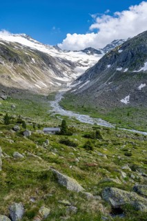 Picturesque mountain landscape, behind mountain peak with snow and glacier Hornkees, valley with