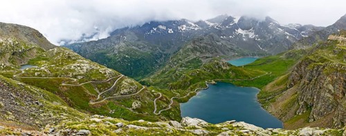 Panoramic view of left serpentines narrow bends from ascent pass road to alpine pass Colle del Col