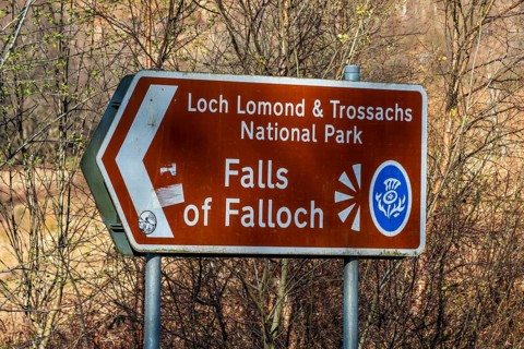 Signpost, waterfall Falls of Falloch, Loch Lomond NP, Scotland, UK