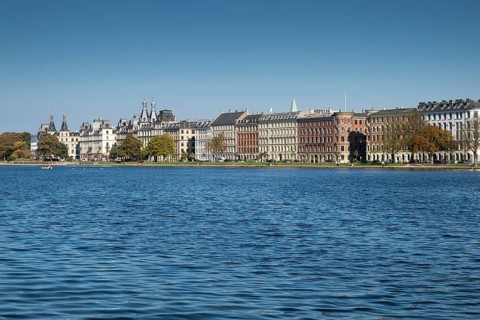 Historic buildings on the waterfront under a blue sky, Søerne, Sortedams Sø, Copenhagen Lakes,