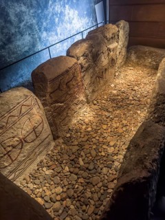 Carved figures in stone slabs inside the King's Tomb, a Bronze Age tomb in Kivik, Simrishamn