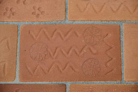 Brick kiln with zigzag design and circular patterns, on a tiled floor, Patmos Cotto Brickworks,