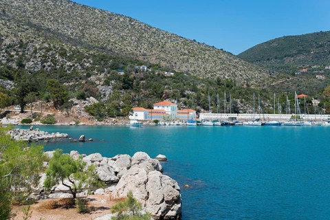 Harbour with boats in front of a picturesque mountainous landscape by the sea, harbour of Methana,