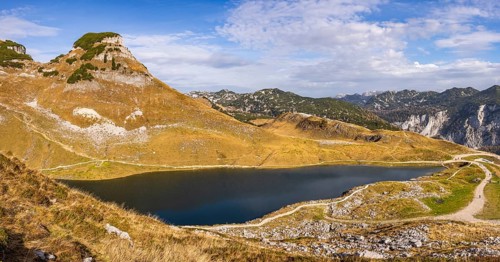 Panorama. Lake Augstsee and the Atterkogel mountain on the Loser. View of other mountains. Autumn,