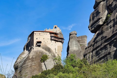 Monastery of St Nikolaos Anapavsas on a rock, sandstone formation, Meteora, blue sky, spring