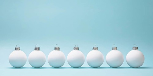 White Christmas tree baubles in a row on pastel blue background. Generative AI, AI generated