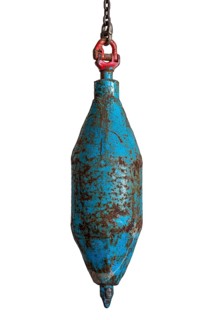 Big plummet, plumb bob level with chain used for digging mine shaft in coal mining, close-up on
