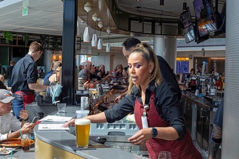 Denver, Colorado, Workers at bar dough, an airport restaurant and bar, serve travelers at Denver