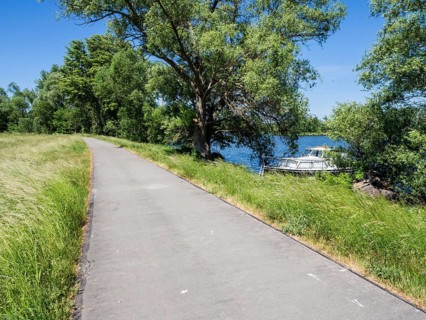 Havel cycle route, route between city Brandenburg and village Werder, leisure boats anchor at bank
