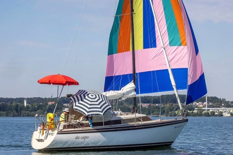 Sailing party on Lake Constance, yacht with colourful foresail and sunshades, Immenstaad,