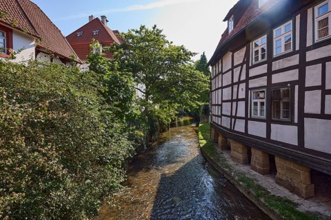 Historic half-timbered houses on the Salze river backlit in the town centre of Bad Salzuflen, Lippe