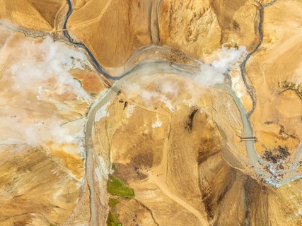 Steaming hot springs and colourful rhyolite mountains, aerial view, Hveradalir geothermal area,