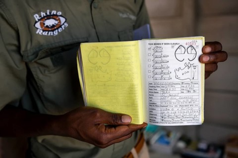 A ranger of the Rhino Rangers shows the data sheet of a rhino sighting, black rhino (Diceros