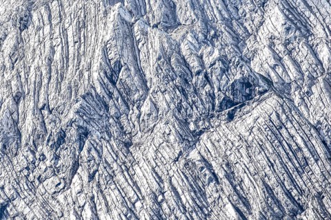 Rock bands or stratifications in the limestone of the Hochkalter Mountains, abstract background,