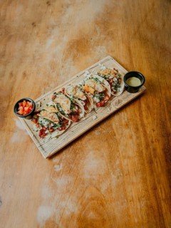 Mexican pork carnita tacos on wooden table with copy space. Homemade Mexican tacos al pastor with