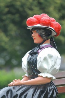 Doll in woman's traditional costume with Bollenhut on bench, Black Forest, Bollenhut, clothing,