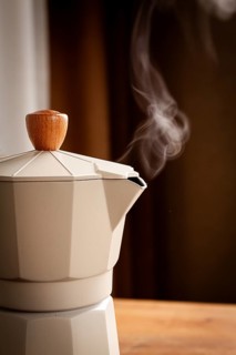 Geyser coffee maker, beige, close-up, boiling, steam from the spout, morning, breakfast, no people
