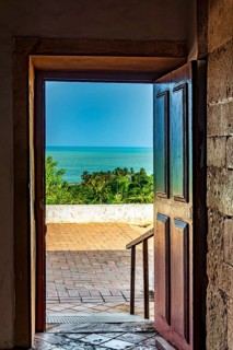 Old wooden door open inside the church overlooking the sea in the city of Olinda in Pernambuco,