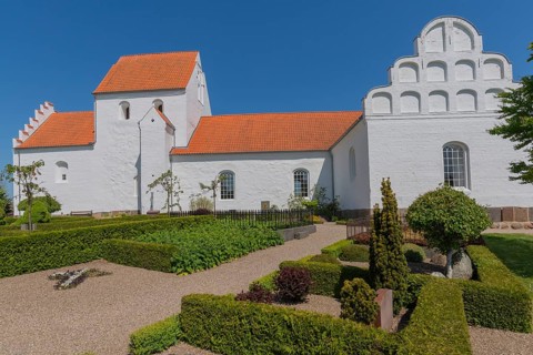 Typical Danish church with Renaissance gable in Hesselager, whitewashed, red tiled roof, curved