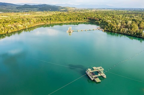 Aerial view of turquoise quarry pond of a gravel pit, Burkheim, Rhine valley, Germany, Europe