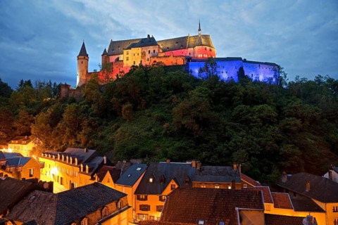 Vianden Castle, hilltop castle illuminated in the colours of the Luxembourg flag for the bank