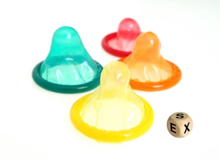 Coloured condoms and cubes with the inscription: SEX, Studio