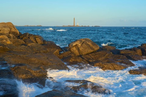 Lighthouse Phare I'Ile Vierge on the island llle Vierge, in the foreground a rocky coastal