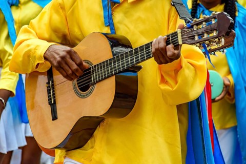 Guitarist playing his instrument during a popular religious festival in the state of Minas Gerais,